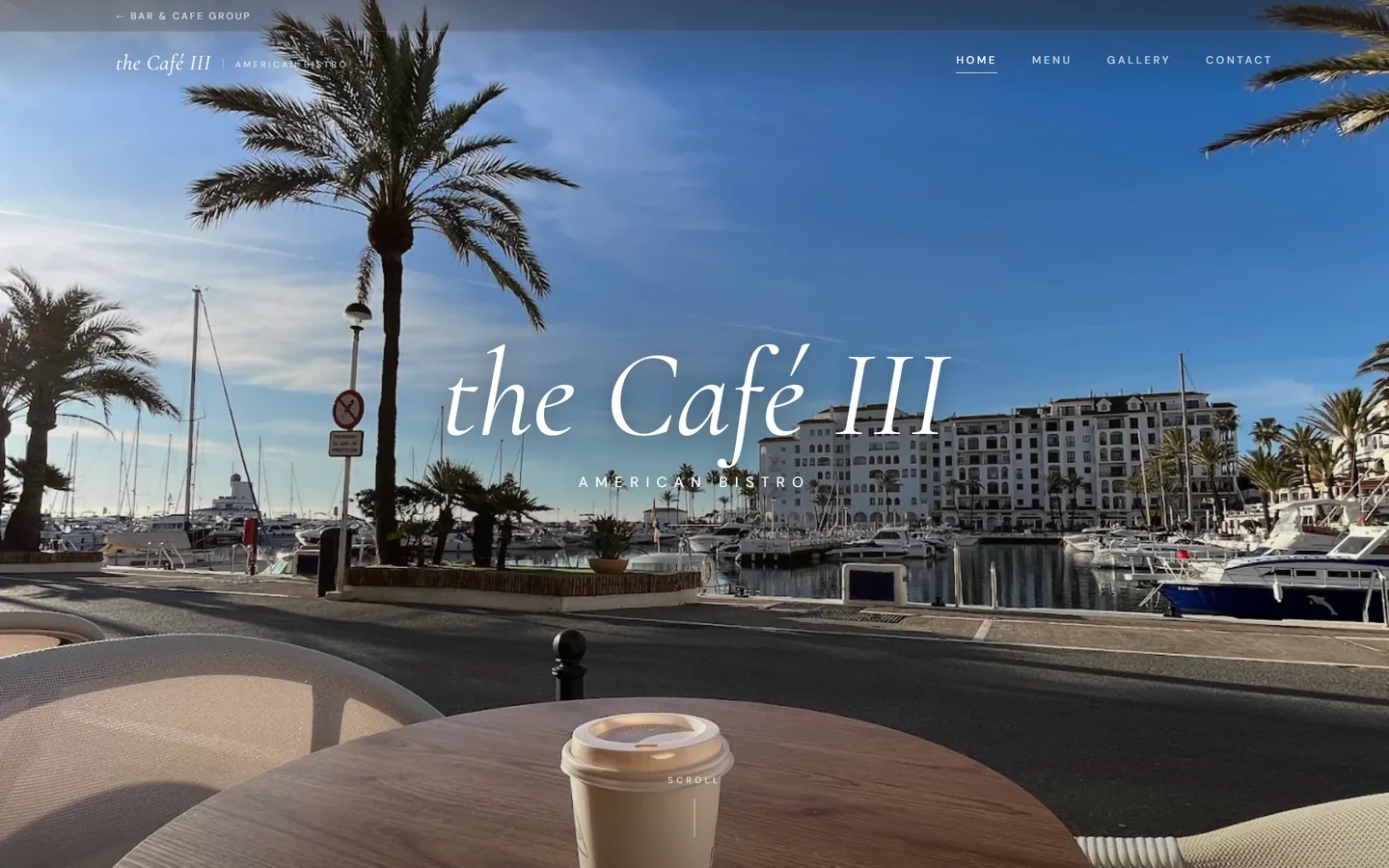 The Cafe III American Bistro website — a light, elegant italic serif wordmark over the Duquesa marina