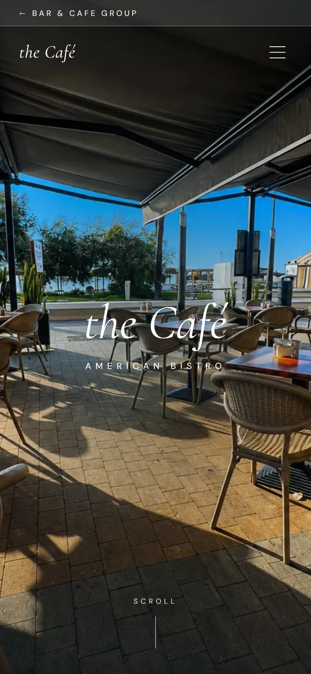 The Cafe American Bistro website on a phone — an elegant serif wordmark over the beachfront terrace